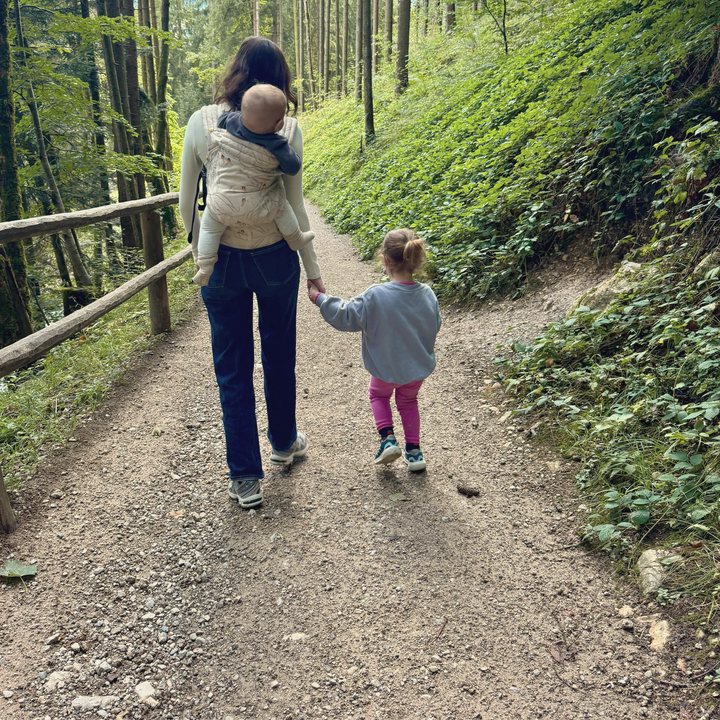 Shir walking a forest trail with her kids
